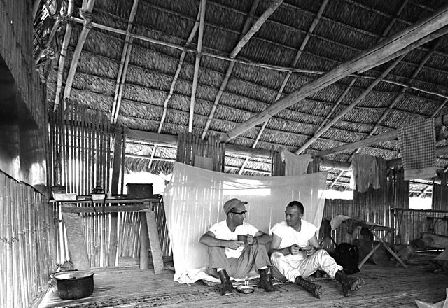 Ted Long and Chuck Clark in their hut in the Amazon Rainforest